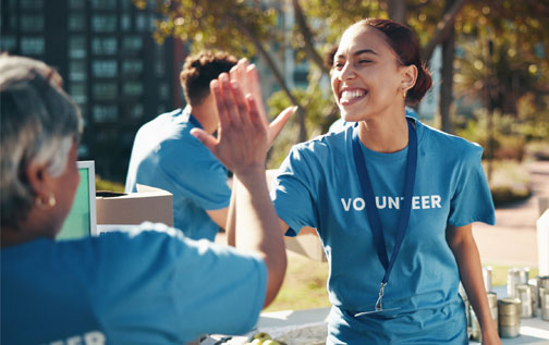 Two volunteers high-fiving